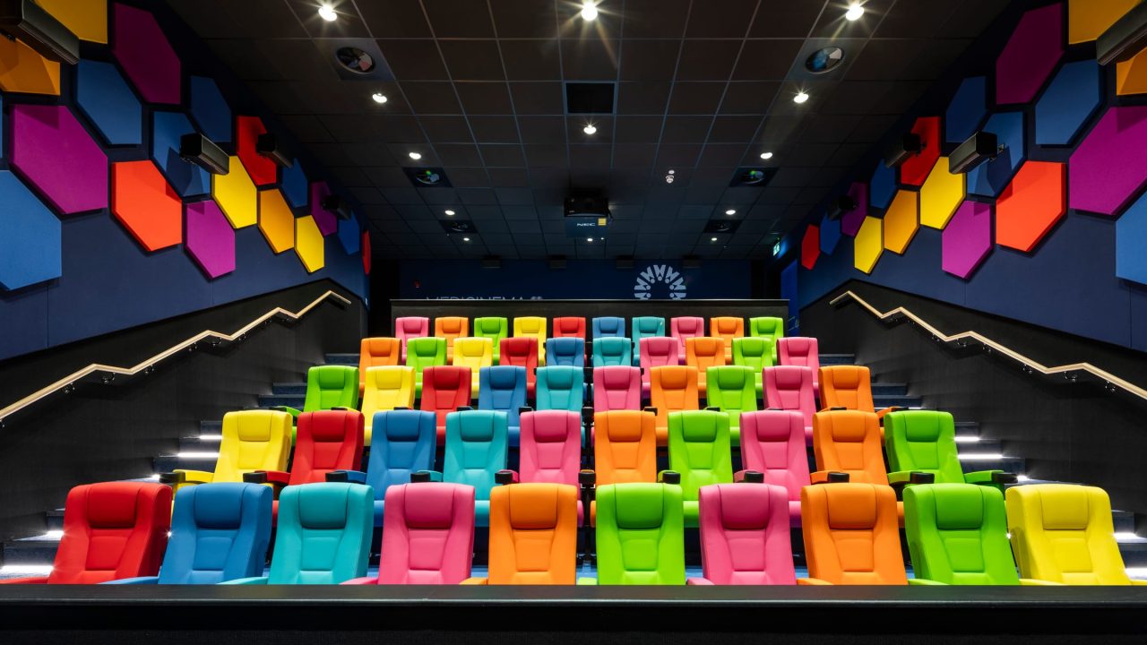 The completed MediCinema auditorium at Manchester Royal Infirmary, seen from the front, with tiered multicoloured seating