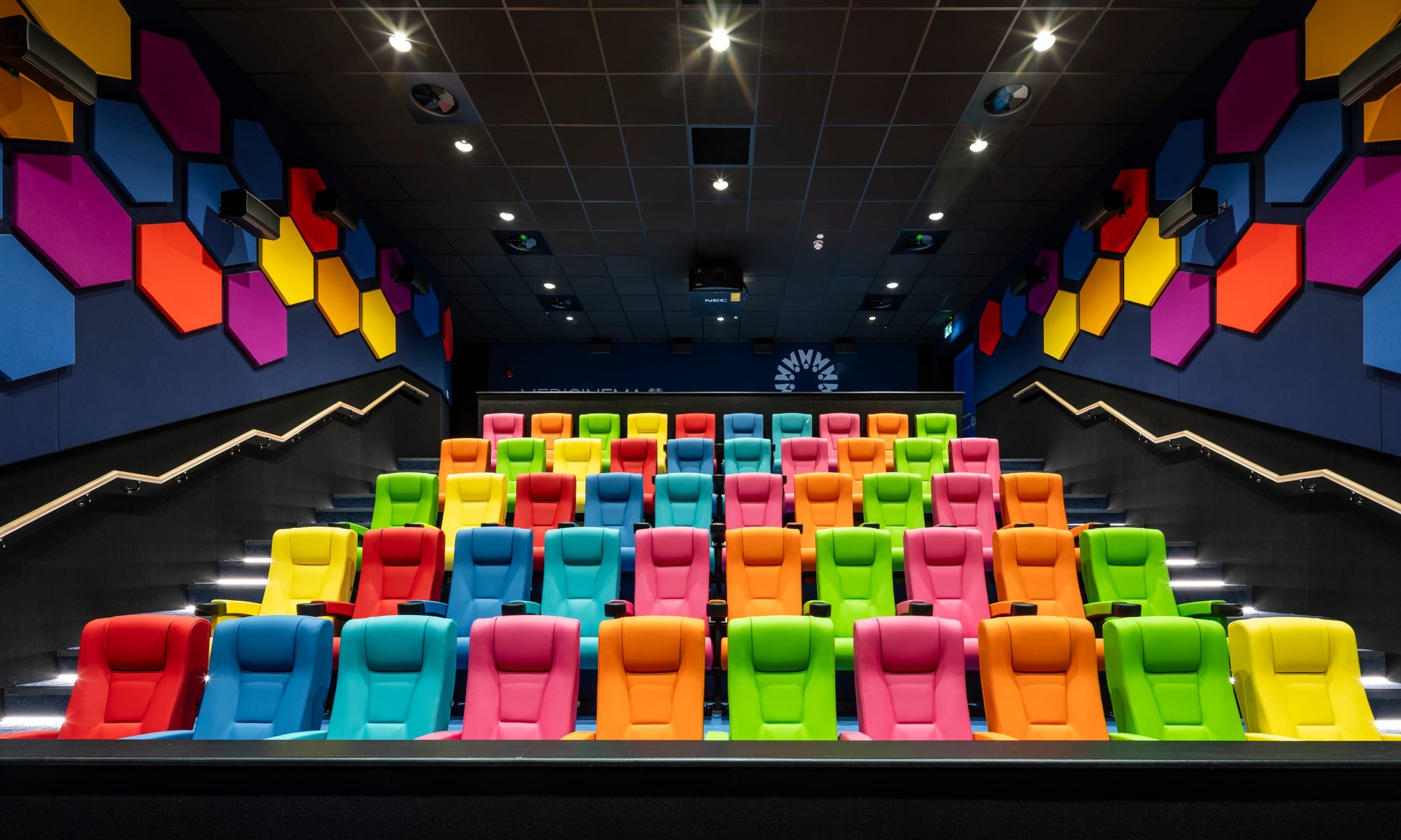 The completed MediCinema auditorium at Manchester Royal Infirmary, seen from the front, with tiered multicoloured seating